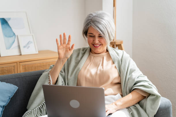 istock Senior woman video calling on laptop at home 2152161782
