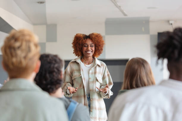 istock Young woman giving presentation to university students 2152162659