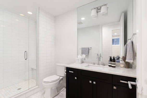 istock A bathroom with a black cabinet and white subway tile shower. 2152166559