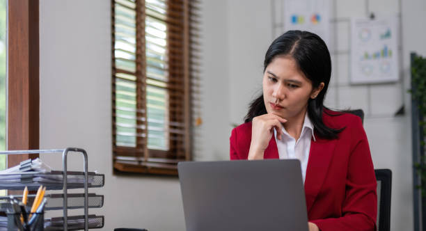 istock Young businesswoman has problems with her work in the office Feeling stressed and unhappy, showing a serious expression 2152166561