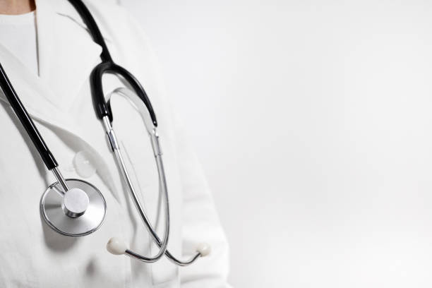 istock Doctor in a white medical coat with a phonendoscope around his neck with copy space 2152167295