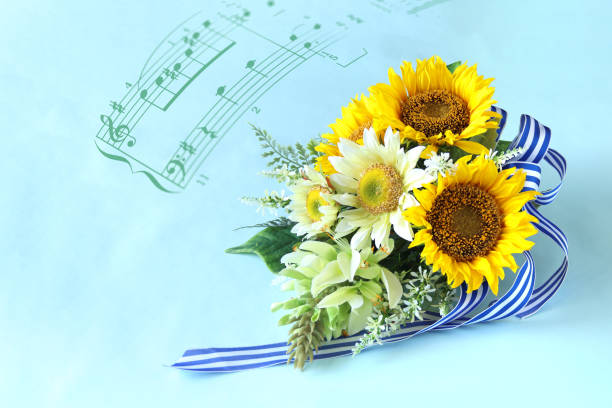 istock sunflowers wedding bouquet with blue background. / music scores 2152169049