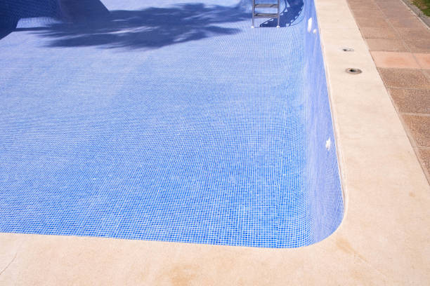 istock An empty swimming pool in a residential area undergoing repair and sealing work. 2152173150