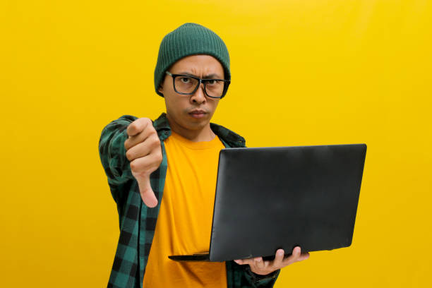 istock Asian man expresses dissatisfaction with a thumbs down 2152173151