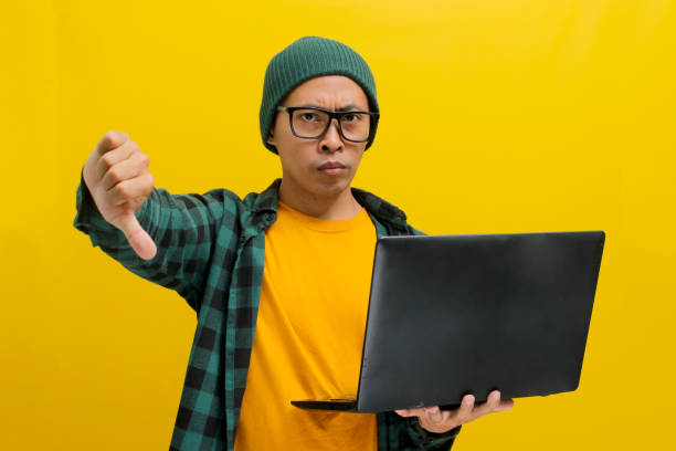 istock Asian man expresses dissatisfaction with a thumbs down 2152173447