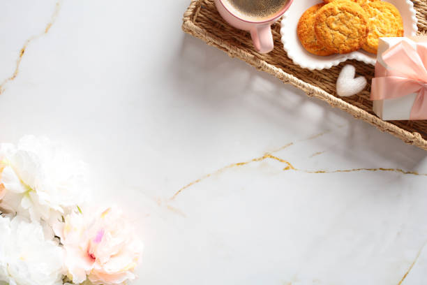 istock Happy mother's day breakfast in wicker tray with flowers on marble table. Top view 2152173578