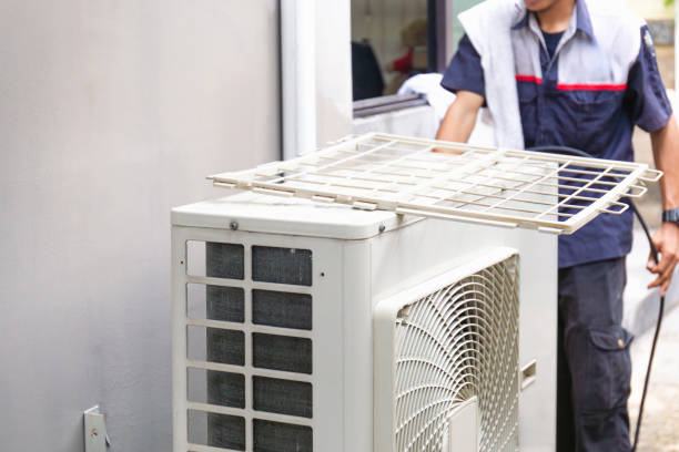 istock Selective focus of Air conditioner compressor with blurred technician man cleaning air conditioner in background, Repairman washing dirty compartments air conditioner 2152175431