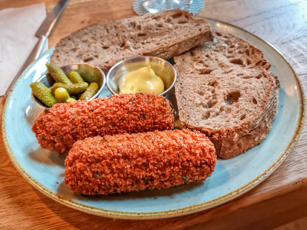 Typical Kroketten (Dutch Beef Croquettes) served with brown bread, butter and pickles