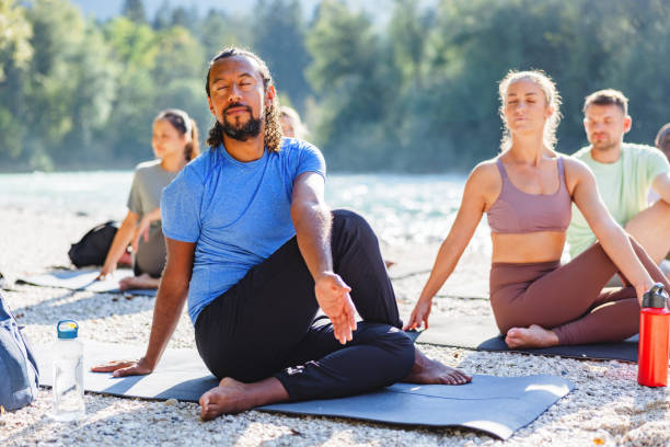 istock Group Yoga Session on a Sunny Beach 2152176220
