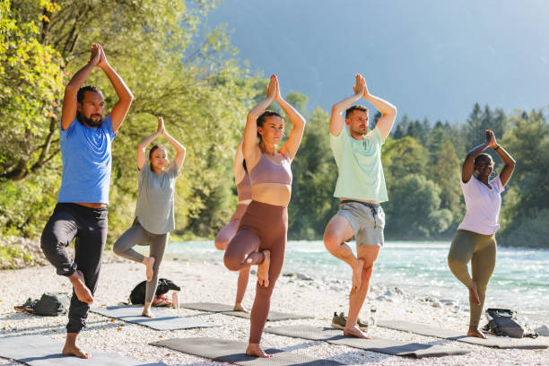 Outdoor Yoga Session by River with Diverse Group