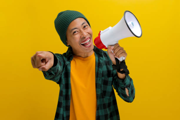 istock Excited Asian Man Shouts into Megaphone 2152178118