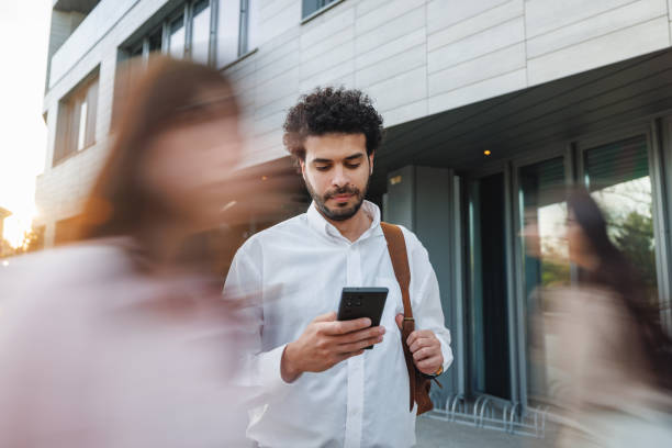 Businessman Checking Smartphone Outside Office