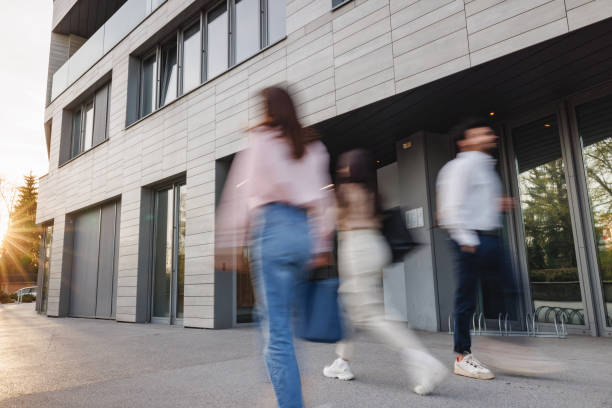 istock Dynamic Business People Exiting Office Building at Sunset 2152179081