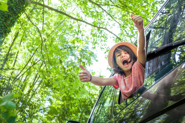 istock A young boy is in a van window, giving thumbs up and laughing 2152179983