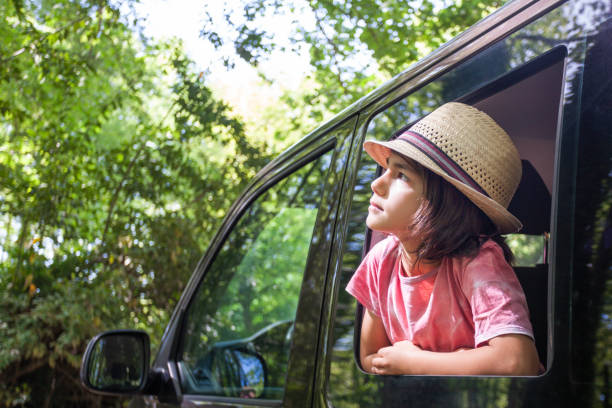 istock A young boy is sitting in a car with her hat on 2152180237