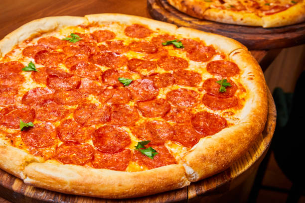 istock Pepperoni pizza with pepperoni sausage, mozzarella cheese and herbs 2152180593