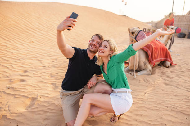 istock Young Tourists Before A Camel Ride In Dubai 2152180919
