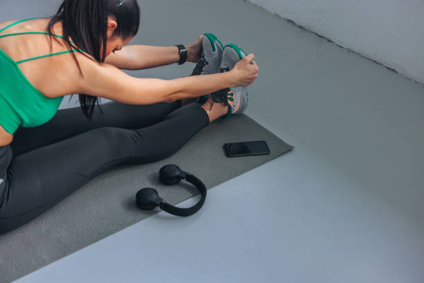 istock Young woman stretching on a yoga mat. 2152182194