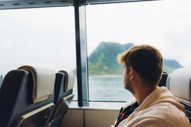 istock Man Crossing Sea by Ferry Boat Admiring Mountain View 2152182556