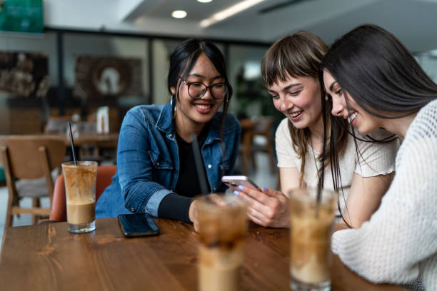istock Group of female friends drinking coffee in a cafe 2152183500
