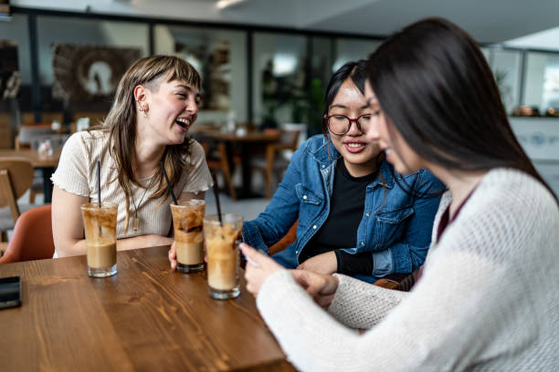 istock Group of female friends drinking coffee in a cafe 2152183654