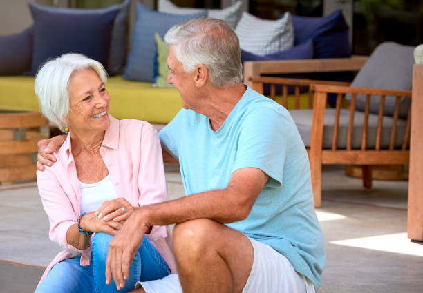 istock Loving Senior Couple Sitting Outdoors On Deck At Home Together 2152184003