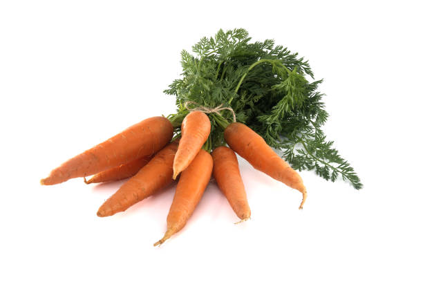 istock Fresh carrots with green leafy tops isolated on white 2152190160