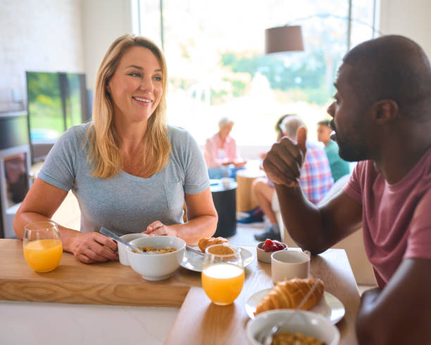 istock Parents Eating Breakfast Together With Three Generation Family In Background 2152192323