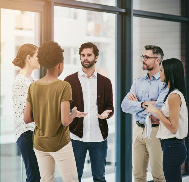 istock Business people, talking or networking at meeting in office with b2b, sharing ideas or planning project. Collaboration, professional employees or discussion in workplace with speaker or brainstorming 2152194714