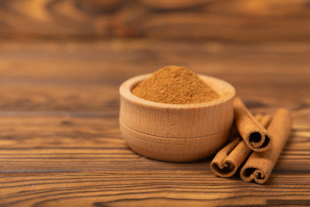 istock Cinnamon sticks on a textured wooden background. Cinnamon roll. Spicy spice for baking, desserts and drinks. Fragrant ground cinnamon. cinnamon powder Close-up. Place for text. copy space 2152195264