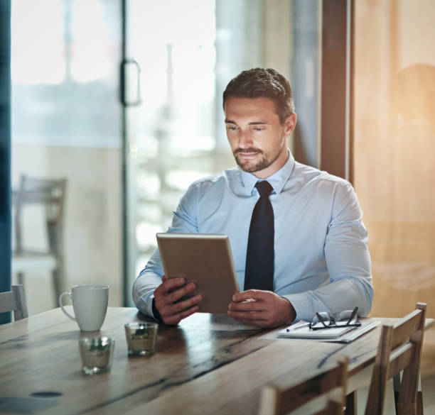 istock Tablet, reading and business man in office for online project, website review and networking. Financial consultant, corporate and worker on digital technology for research, report and planning 2152195783