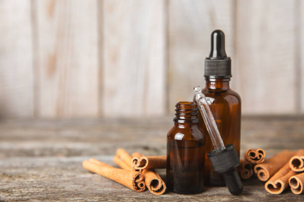 istock Cinnamon aromatic essential oil and cinnamon sticks on background. Aromatherapy. Organic cosmetic oil. Spa concept. Place for text. Copy space. 2152195887