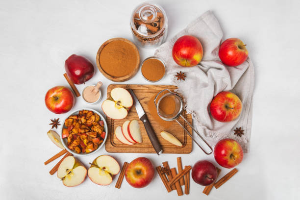 istock Apples with cinnamon on a textured wooden background. Fragrant red spiced apples with cinnamon sticks and star anise. Apple slices with spicy spices. Place for text. Copy space. Harvesting. Fruits. 2152196057