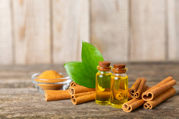 istock Cinnamon aromatic essential oil and cinnamon sticks on  background. Aromatherapy. Organic cosmetic oil. Spa concept. Place for text. Copy space. 2152196603