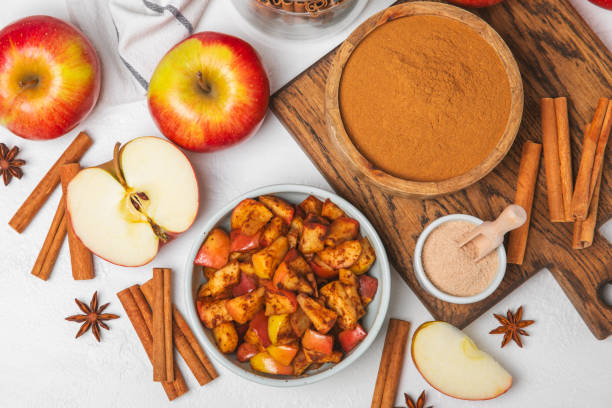 istock Apples with cinnamon on background. Fragrant red spiced apples with cinnamon sticks and star anise. Apple slices with spicy spices. Place for text. Copy space. Harvesting. Fruits. 2152196754