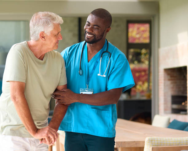 istock Male Nurse Visiting Senior Man Using Walking Stick With Mobility Issues At Home 2152198092