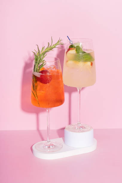 istock Two colourful cocktails with ice on podiums on pink background. 2152198594