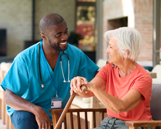 istock Male Nurse Visiting Senior Woman Using Walking Stick With Mobility Issues At Home 2152198635