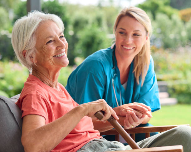 istock Female Nurse Visiting Senior Woman Using Walking Stick With Mobility Issues At Home 2152199278