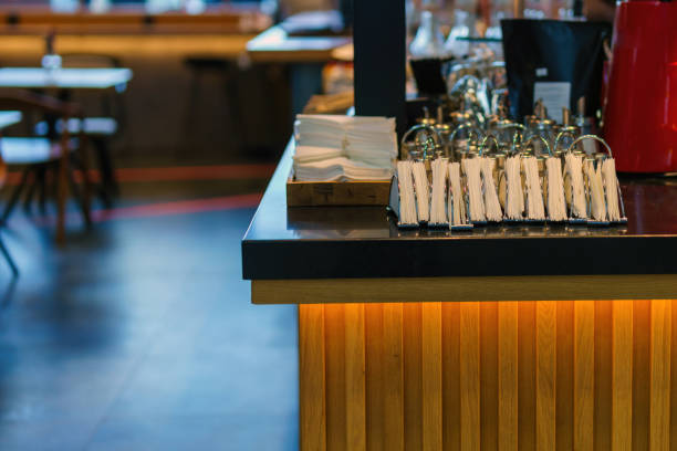 Napkins and a set of spices for table setting on a bar counter