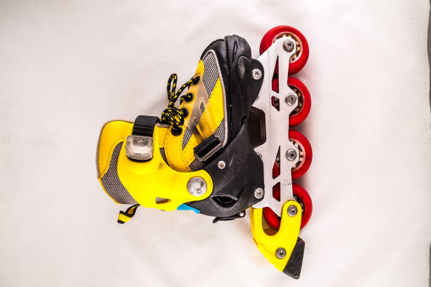 istock A yellow and black roller skate with red wheels 2152202674