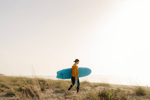 istock Surfer girl and her surfboard 2152203205