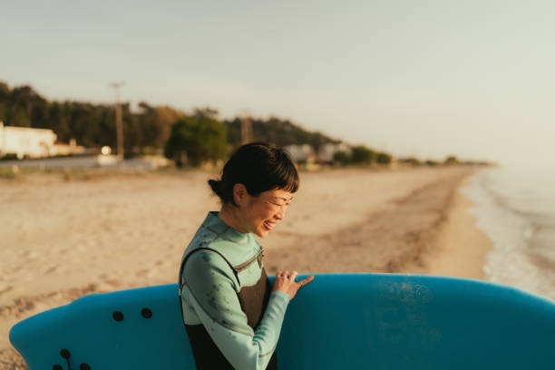 istock Surfer girl and her surfboard 2152203317