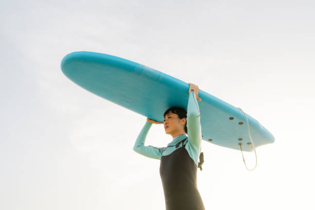 istock Surfer girl and her surfboard 2152203332