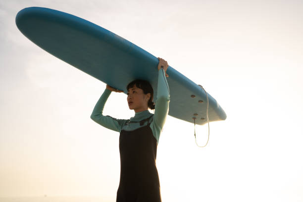 istock Surfer girl and her surfboard 2152203335