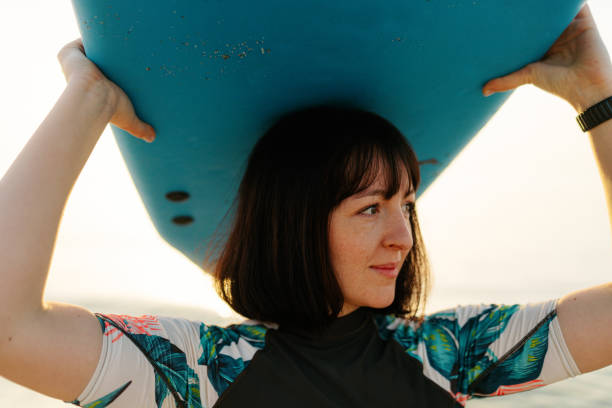 istock Surfer girl and her surfboard 2152203535