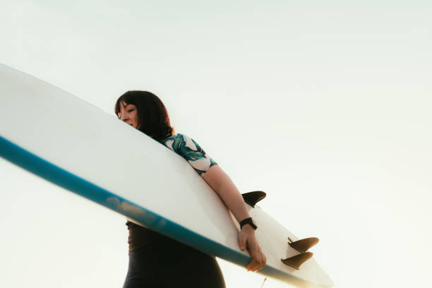 istock Surfer girl and her surfboard 2152203570