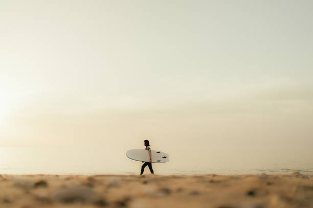 istock Surfer girl and her surfboard 2152203582