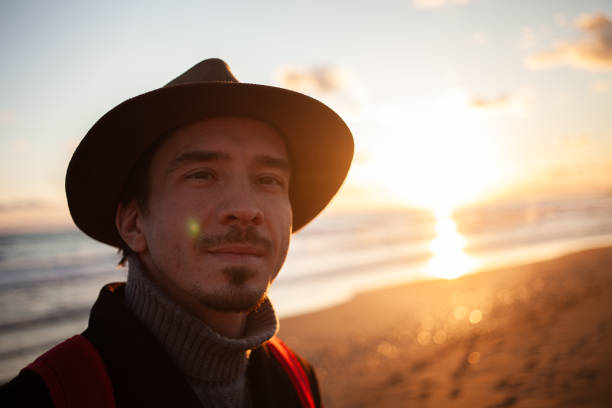 istock Contemplative walk man enjoys sunset by the sea. 2152204247