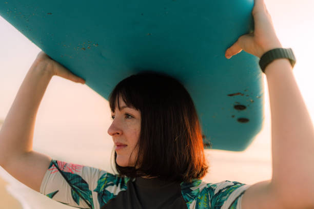 istock Surfer girl and her surfboard 2152204363